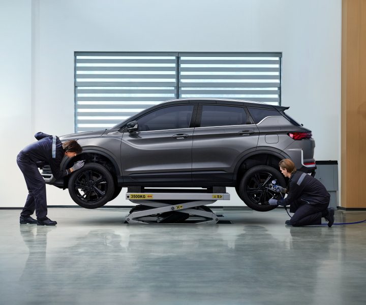 Technicians servicing a Geely