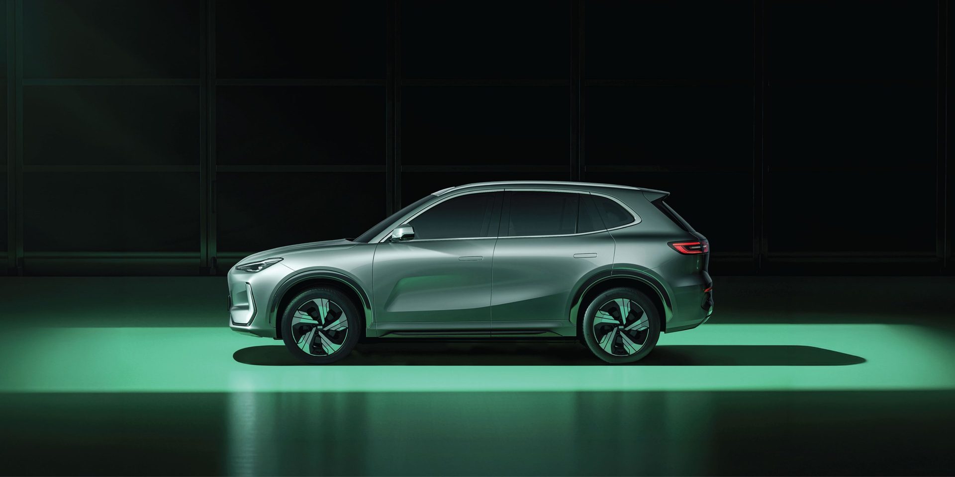 Geely EX5 in a dark studio with green light